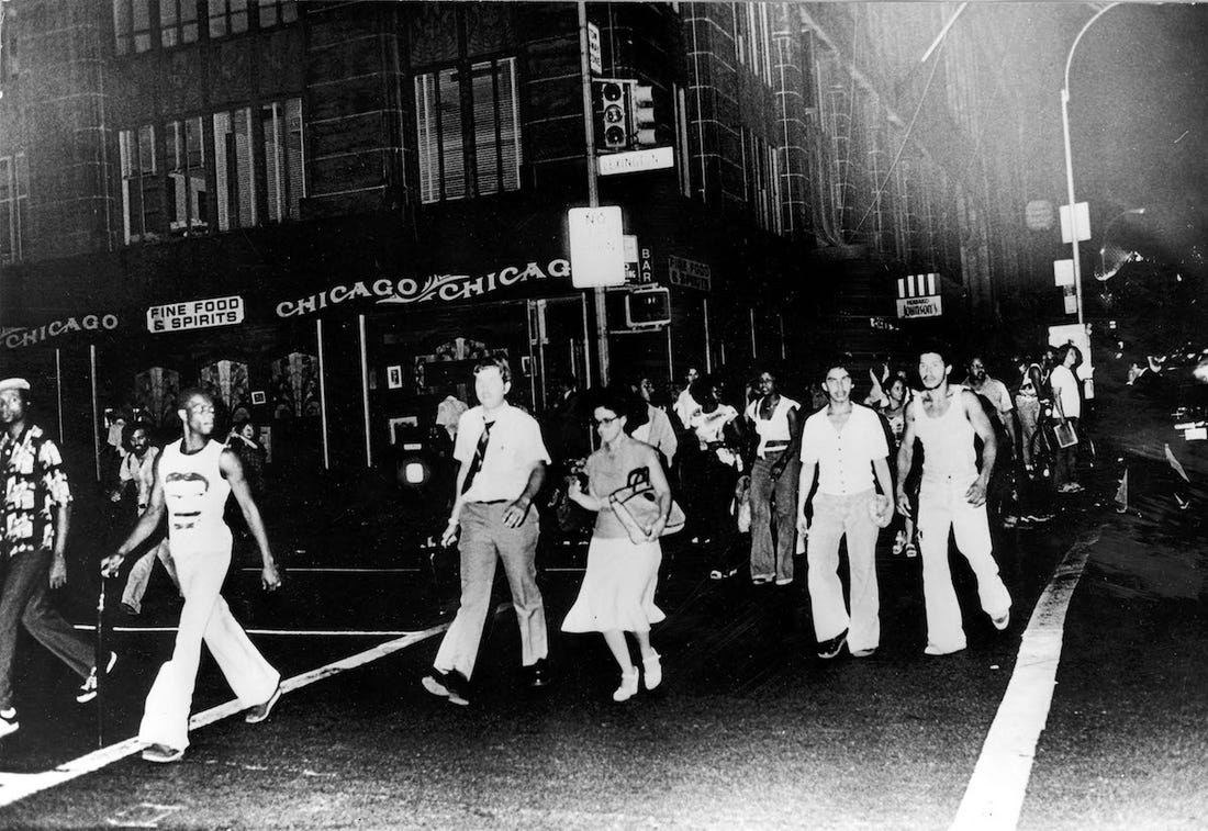 citizens walk the darkened streets of new york city during the blackout of 1977